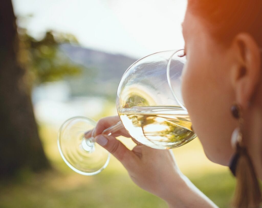 Sniffing glass of wine, wine tasting