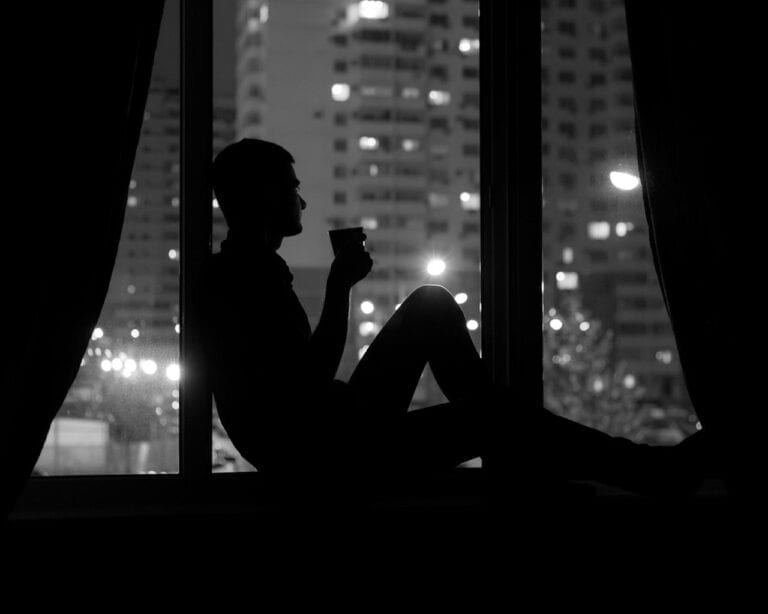 Thoughtful man, city, night