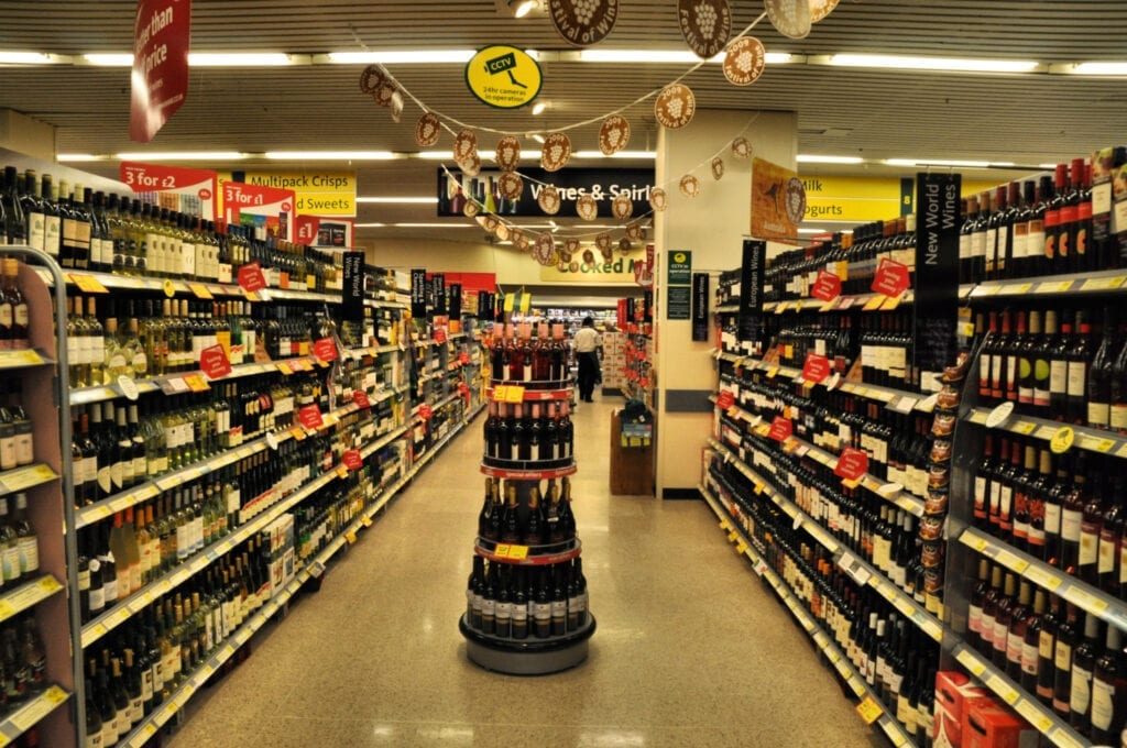 Aisle inside wine shop showing bottles of wine