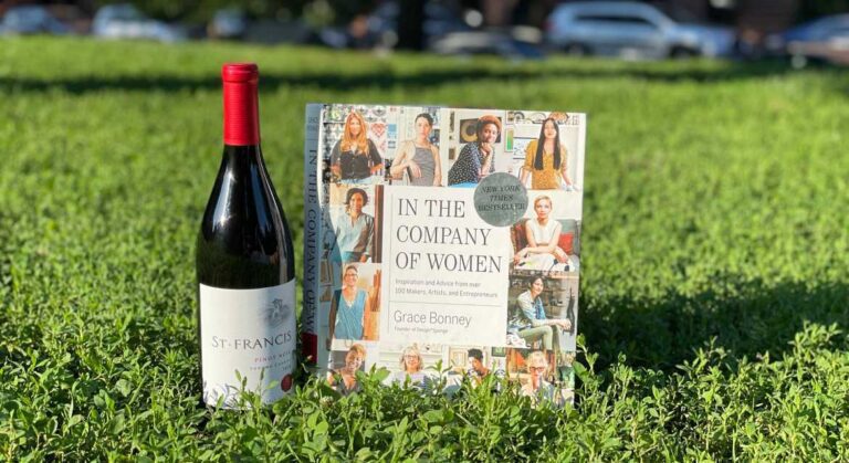 St. Francis Pinot Noir wine and book "In the Company of Women" in the park