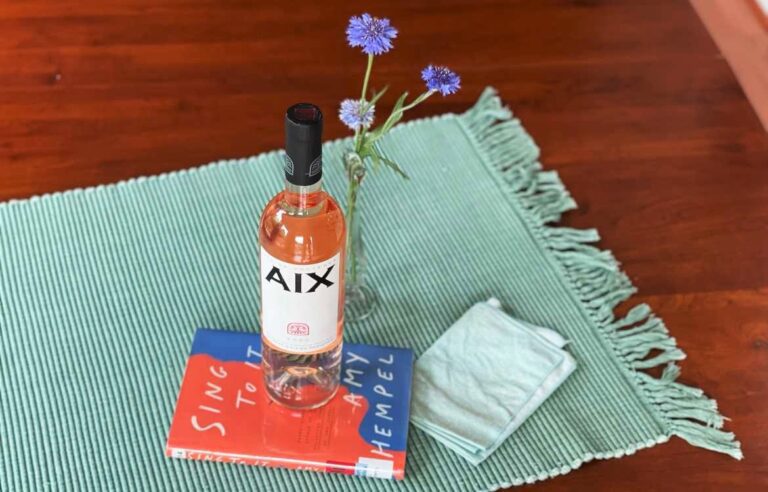 AIX Rose wine and book with flowers