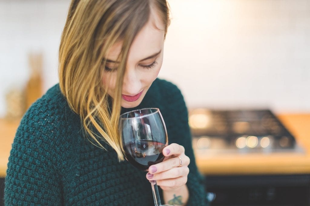 Woman smelling wine in a glass