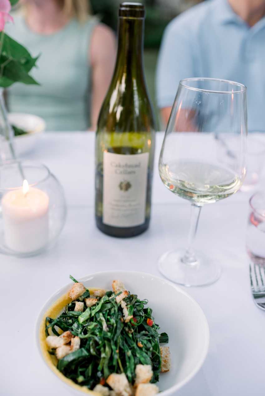 White Chardonnay at dinner table with green food