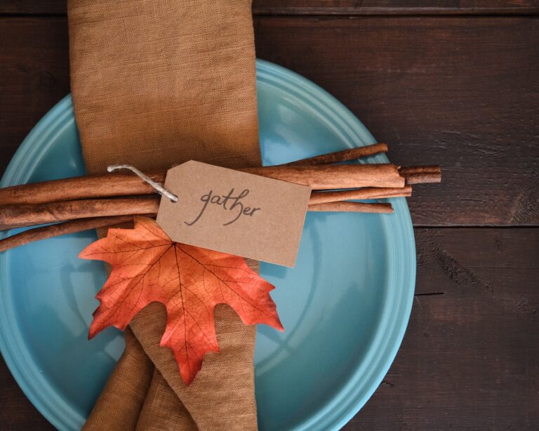 Plate with a napkin ring that says gather