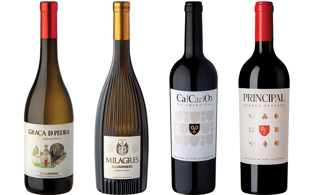 Two bottles of Portuguese white wine and two bottles of red wine from Portugal. Left to right Quinta da Pedra Graca da Pedra Alvarinho, Quinta da Pedra Milagres Alvarinho, Principal CalCariO, and Principal Grande Reserve