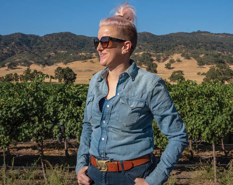 Bezel winemaker Jane Dunkley standing in Paso Robles California vineyards with mountains in the background