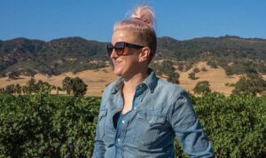 Bezel winemaker Jane Dunkley standing in Paso Robles California vineyards with mountains in the background